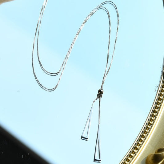Sleek Triangle Tassel Necklace – Platinum Plated Stainless Steel